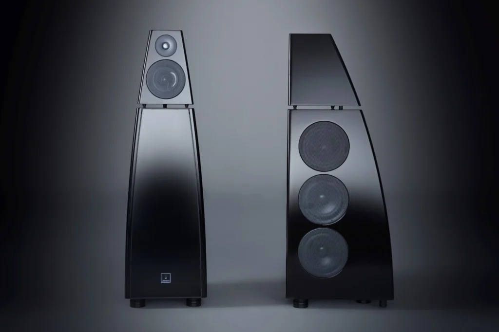 Pair of black pyramidal Meridian loudspeakers photographed against a dark studio background