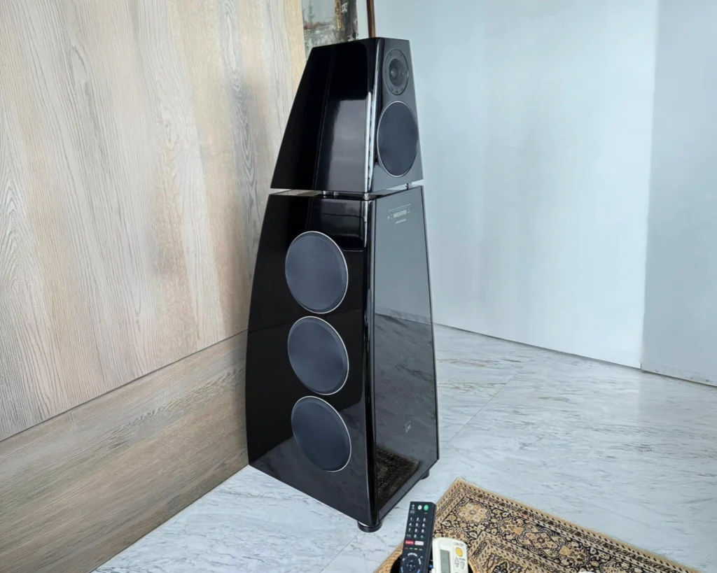 Black Meridian DSP8000 loudspeaker standing in the corner of the finished room, with no visible cabling