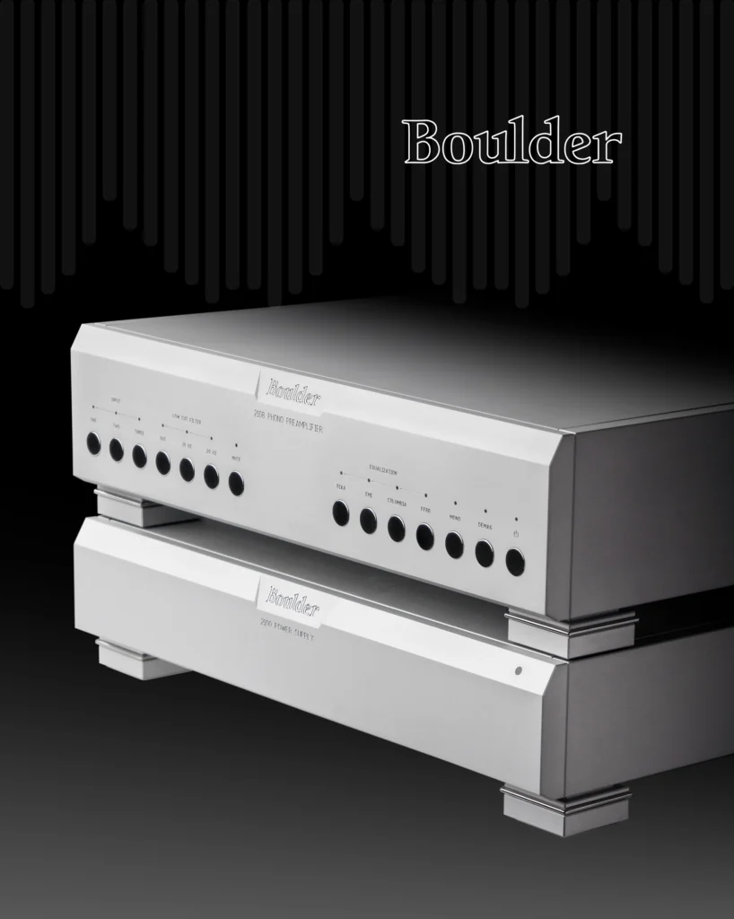 Boulder silver preamplifier above a power amplifier in a three-quarter view against a dark background.