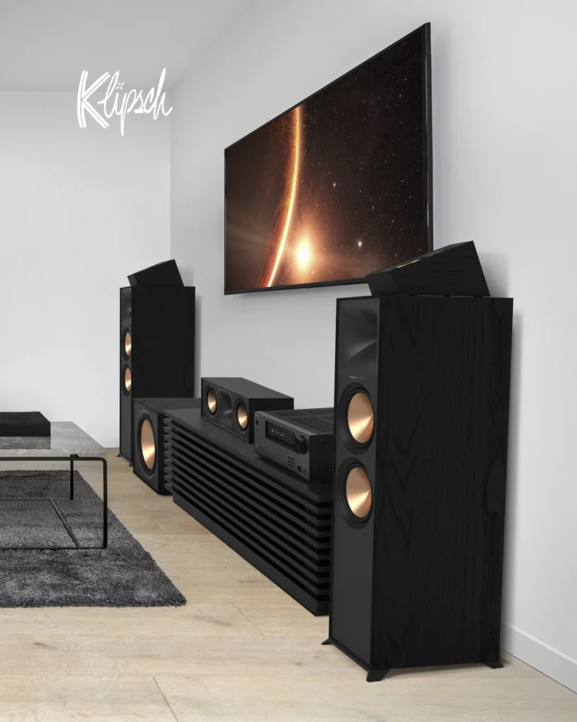 Klipsch home theatre with black floorstanding speakers, a centre channel and a wall-mounted television.