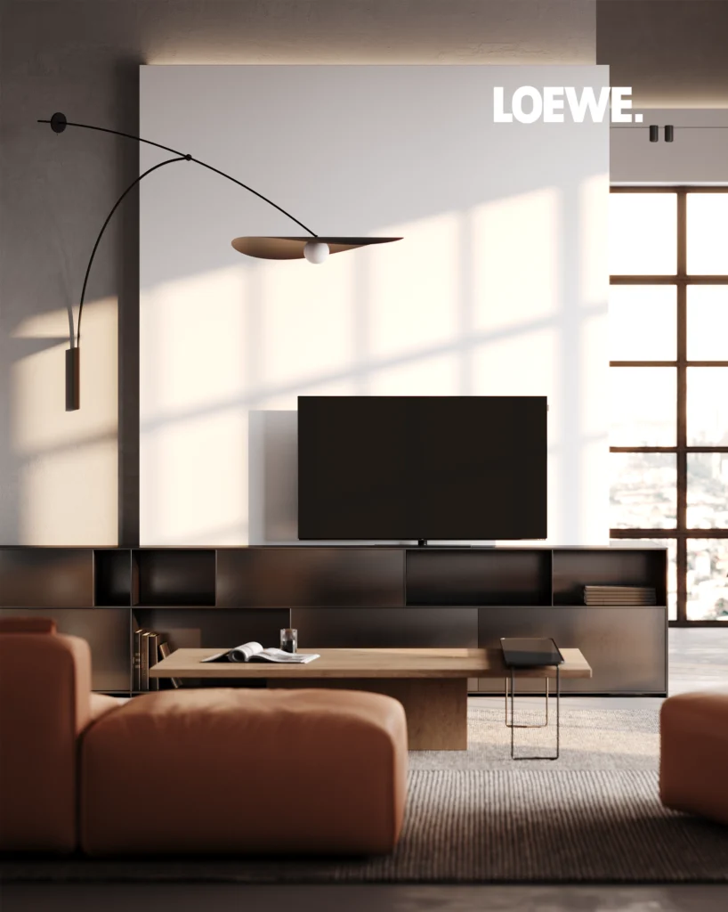 A Loewe television set into dark bronze floating shelving, with an arc floor lamp and orange leather sofas in a city-view living room.