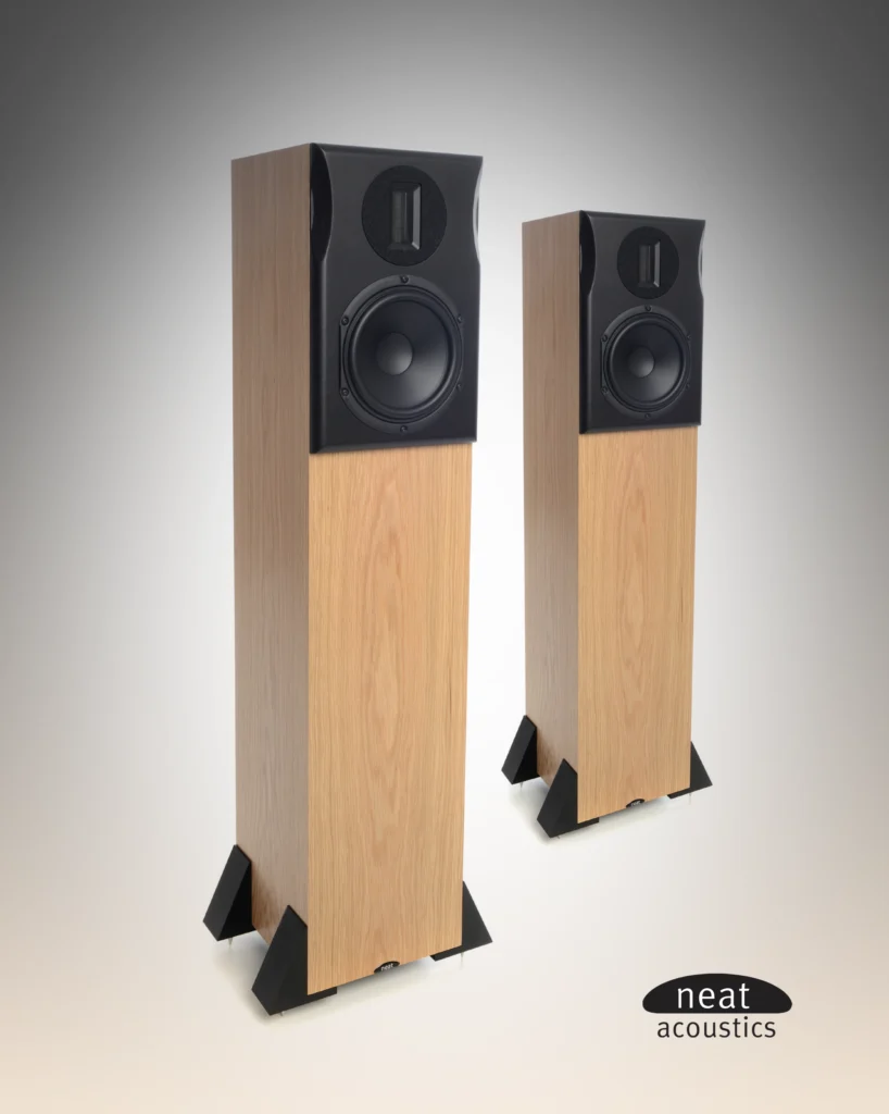 Pair of slim Neat Acoustics floorstanding speakers in light oak with black upper baffles, on outrigger feet.