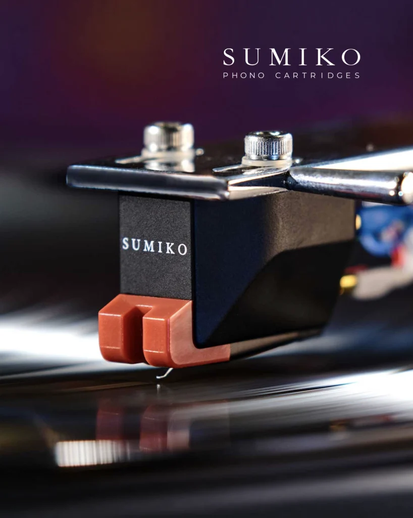 Sumiko phono cartridge with a terracotta-coloured body above a spinning record.
