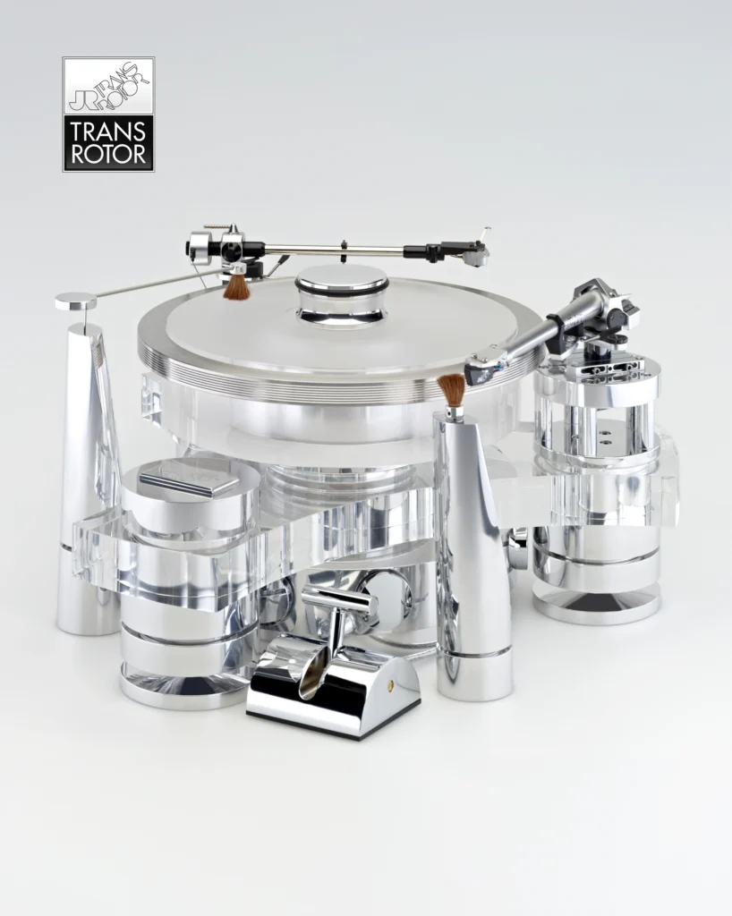 Transrotor turntable in clear acrylic and polished aluminium, with two tonearms and a record clamp.
