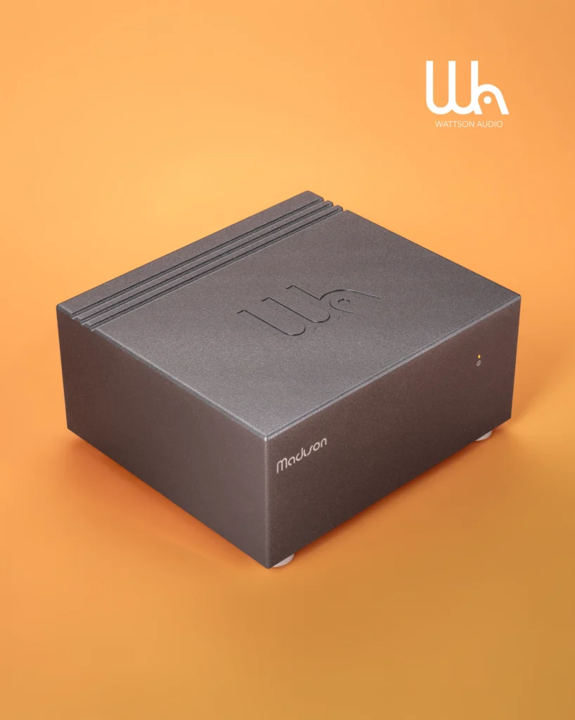 Grey Wattson Audio Madison component with a ridged top, on an orange background.
