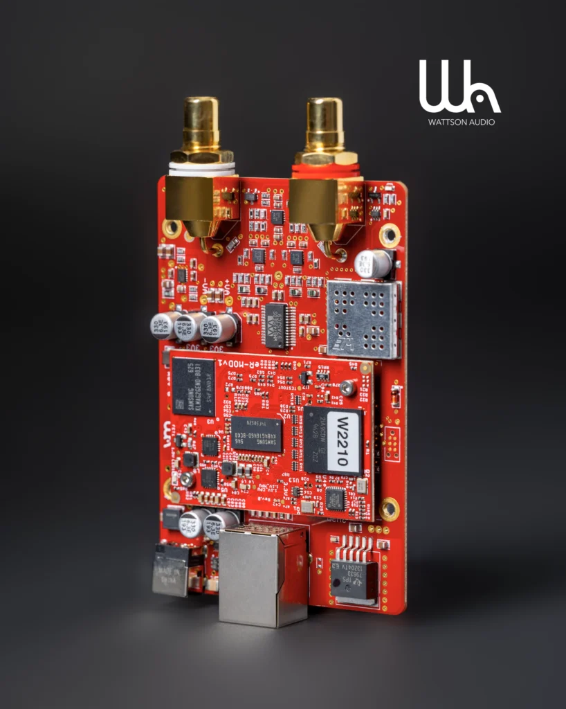 Red Wattson Audio circuit board with gold RCA outputs and a network port, on a dark background.