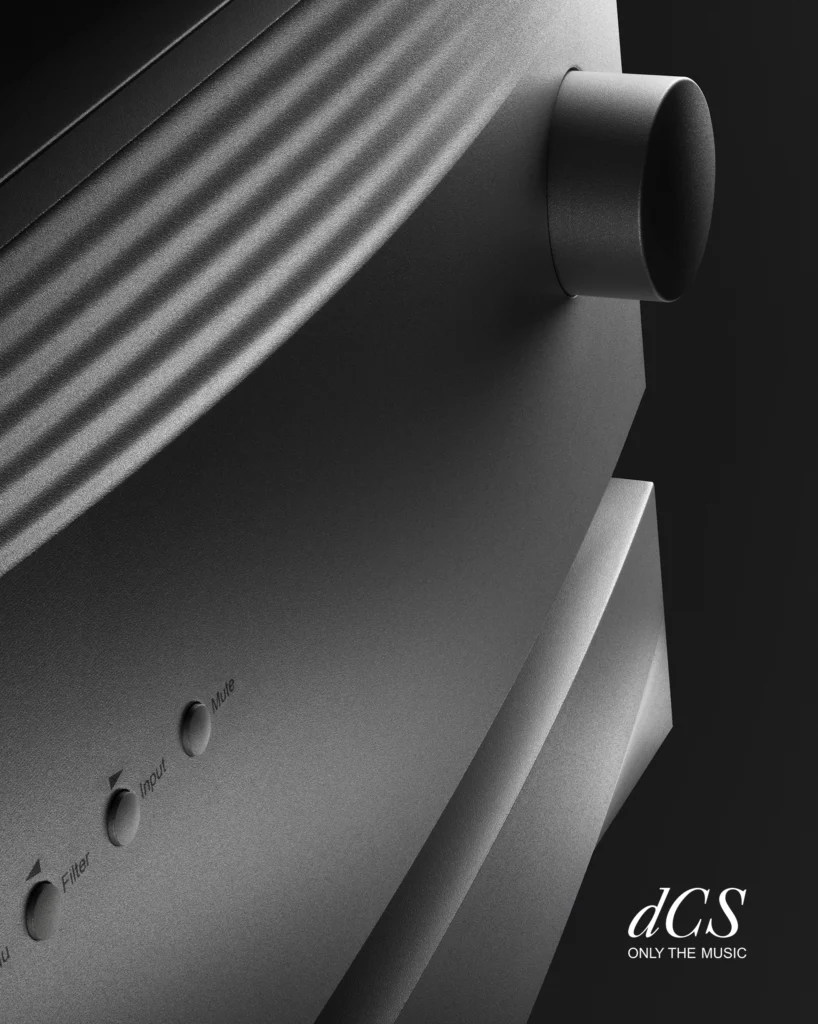 Close-up of a dCS component's machined silver front panel with a large knob and small control buttons.