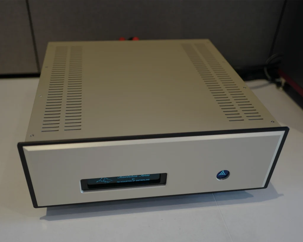Front of a gold-finished power amplifier with a blue display