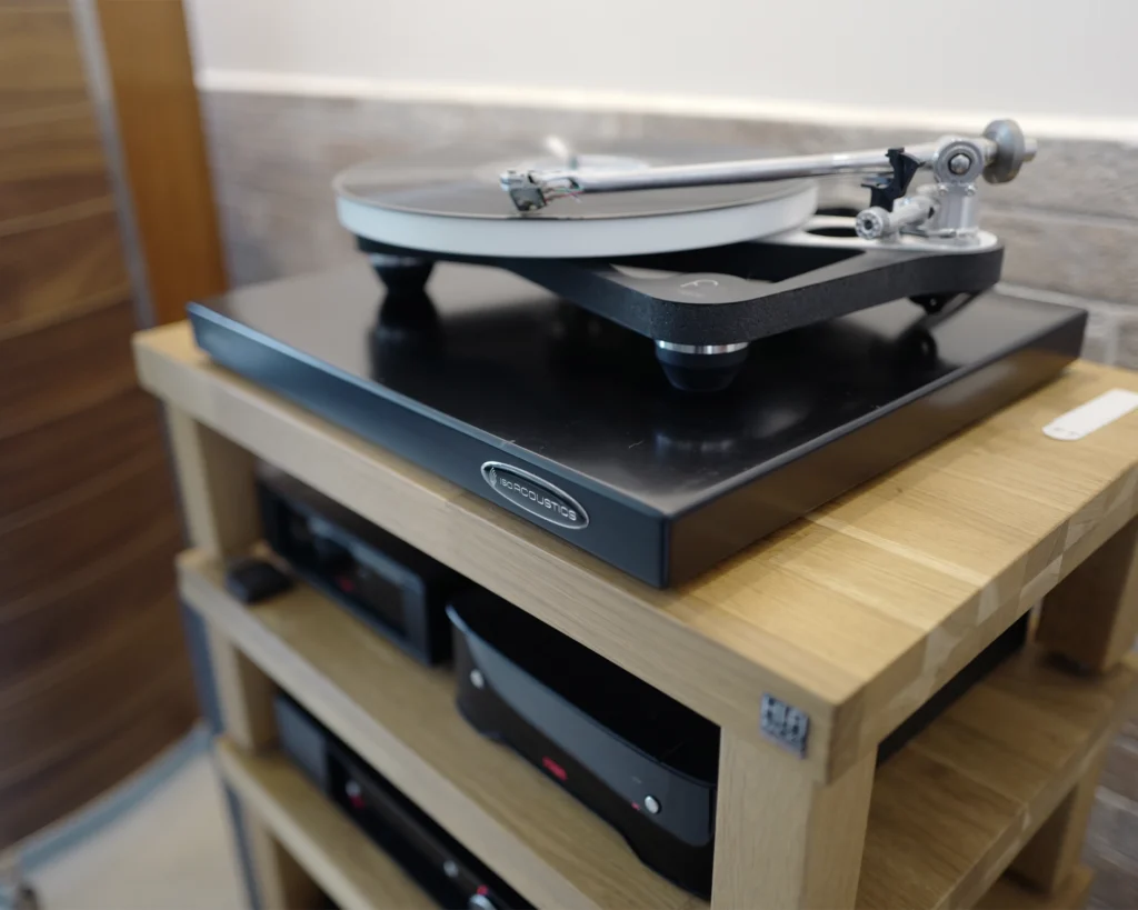 Turntable on an isolation base, set on a timber rack above amplifiers