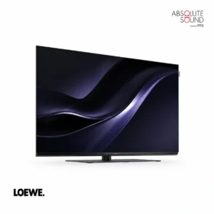 Loewe We. SEE 65 television on a slim central stand, showing an abstract dark blue image.